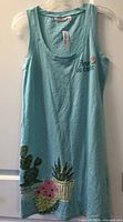 Full view of turquoise sleeveless nightgown with cactus graphic and chest text