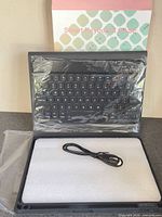Box marked Smart Keyboard Case with keyboard, foam-packed case and charge cable