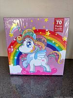 Front of sealed puzzle box showing unicorn and 70 pieces label