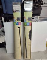 Two sealed RoomMates peel & stick chalkboard decal sets standing upright in packaging