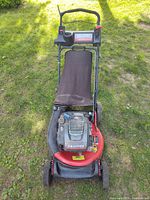 Front view of Snapper lawn mower showing deck, engine, handle and bag