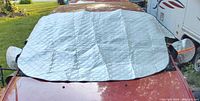 Shield installed on car windshield showing full coverage and mirror flaps