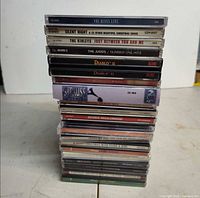 Stack of 20 CDs showing spine titles