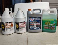 Front view of four one-gallon chemical containers