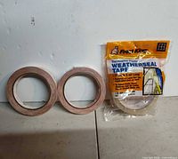 Overall lot with two loose tape rolls and sealed Frost King tape