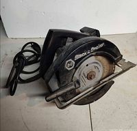 Overall view of Black & Decker corded circular saw showing housing, blade guard, base plate and cord