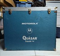 Front of blue Motorola Quasar case showing logos and hardware