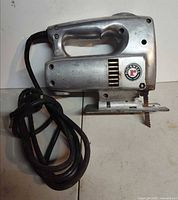 Left side view of Rockwell electric saw showing full body and cord