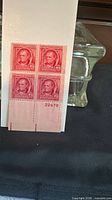Full view of plate block showing four stamps and bottom margin with plate number 22479