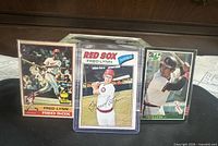 Front view of all three Fred Lynn baseball cards in plastic sleeves