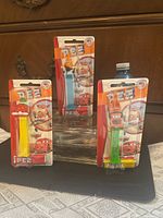 All three factory-sealed PEZ packs standing