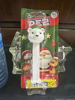 Full view of sealed PEZ dispenser on card beside water bottle for scale