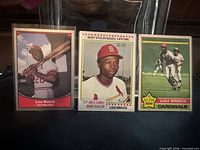 Fronts of all three Lou Brock cards standing upright