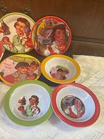 Front view of all eight pieces showing artwork and rims