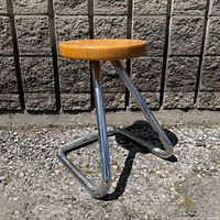 Full view of stool showing chrome frame and wood seat