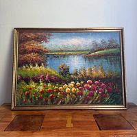 Full view of framed oil on canvas landscape with flowers