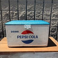 Front view showing Pepsi-Cola logo, latch, overall condition