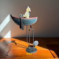 Full view of sailor rowboat balance toy on stand