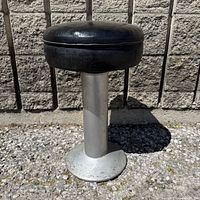 Full view of stool showing seat and pedestal