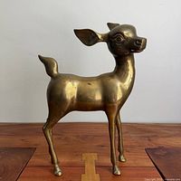 Full view of brass deer sculpture front/side