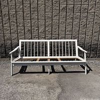Front view of white-painted teak loveseat frame
