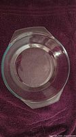 Top view of clear glass round baking dish showing interior and both handles