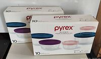 Front view of two sealed Pyrex glass storage set boxes