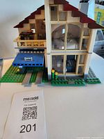 Front view of partially assembled Lego Creator house on baseplate