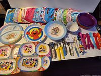 Overall lot showing towels, plates, bowls, cutlery laid out