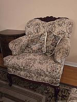 front view of floral upholstered armchair with pillows