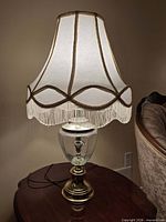 Full view of lamp on table showing shade, base and cord