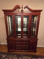 Front view of wooden china cabinet closed