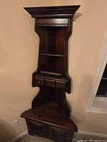 full front view of corner curio cabinet showing overall design