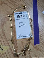 Entire necklace laid out showing knots and overall length