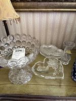 Compote bowl, two heart dishes and bud vase on table