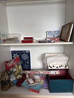 Overall view of two shelves with greeting cards, boxes, wrapping supplies