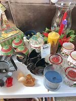 Overview of assorted candles, holders, ceramic pieces on tray
