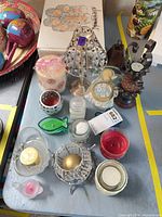 Overall view of assorted candles and holders on table