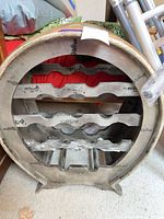 Front of round resin wine rack showing bottle slots