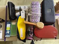 Overall lot showing hair rollers, massager, brush heads, insoles, jade roller box, brush, travel cases