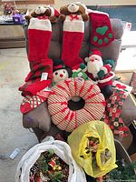 Overview showing stockings, plush figures, wreath, ornaments and greenery