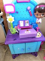 Full view of Doc McStuffins clinic playset with accessories attached