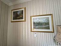 Both framed prints on wall showing matching size and frames