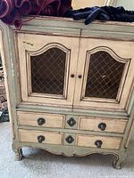 front view of cabinet showing wire mesh doors and two drawers