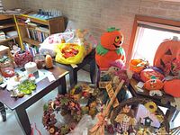 Overall view of lot showing pumpkins, scarecrows, wreaths, candles and dish