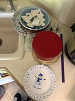 Group shot showing all dinnerware, tin, figurines and tumblers