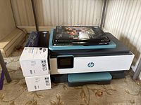 Printer with accessory boxes visible