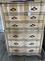 Full front view of six-drawer painted dresser showing serpentine front, hardware and cabriole feet