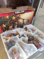Outer box showing Kirkland Signature Nativity imagery and styrofoam insert with figurines
