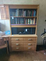 Front view showing six-drawer dresser base and hutch with shelves and electronics bay